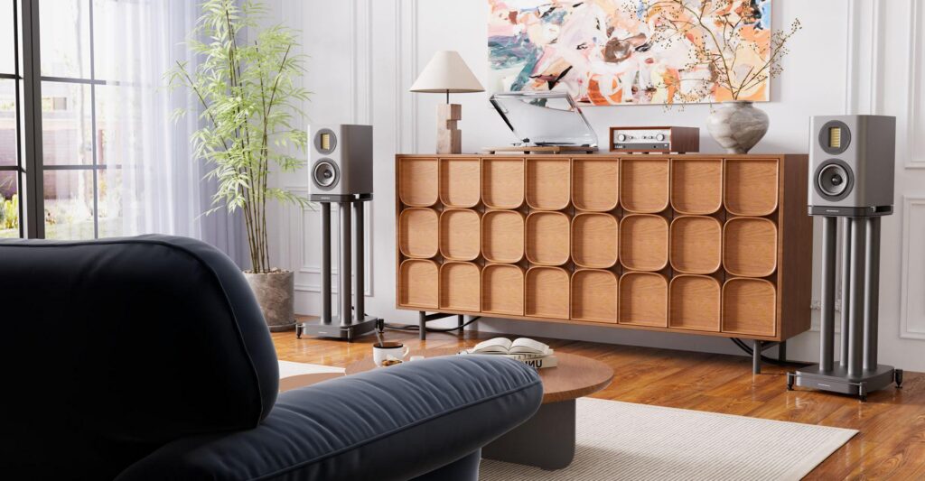 Compact bookshelf stereo speakers positioned on dedicated speaker stands.