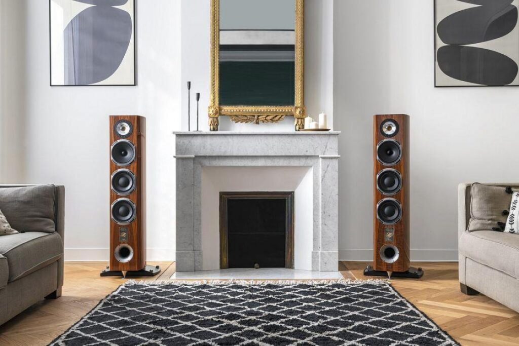 Floorstanding tower speakers delivering full-range audio in a spacious living room.